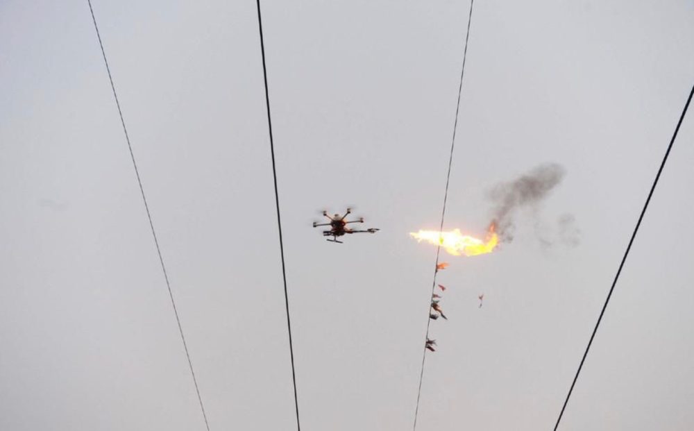Cleaning power lines is easy when you have a flame-throwing drone0004