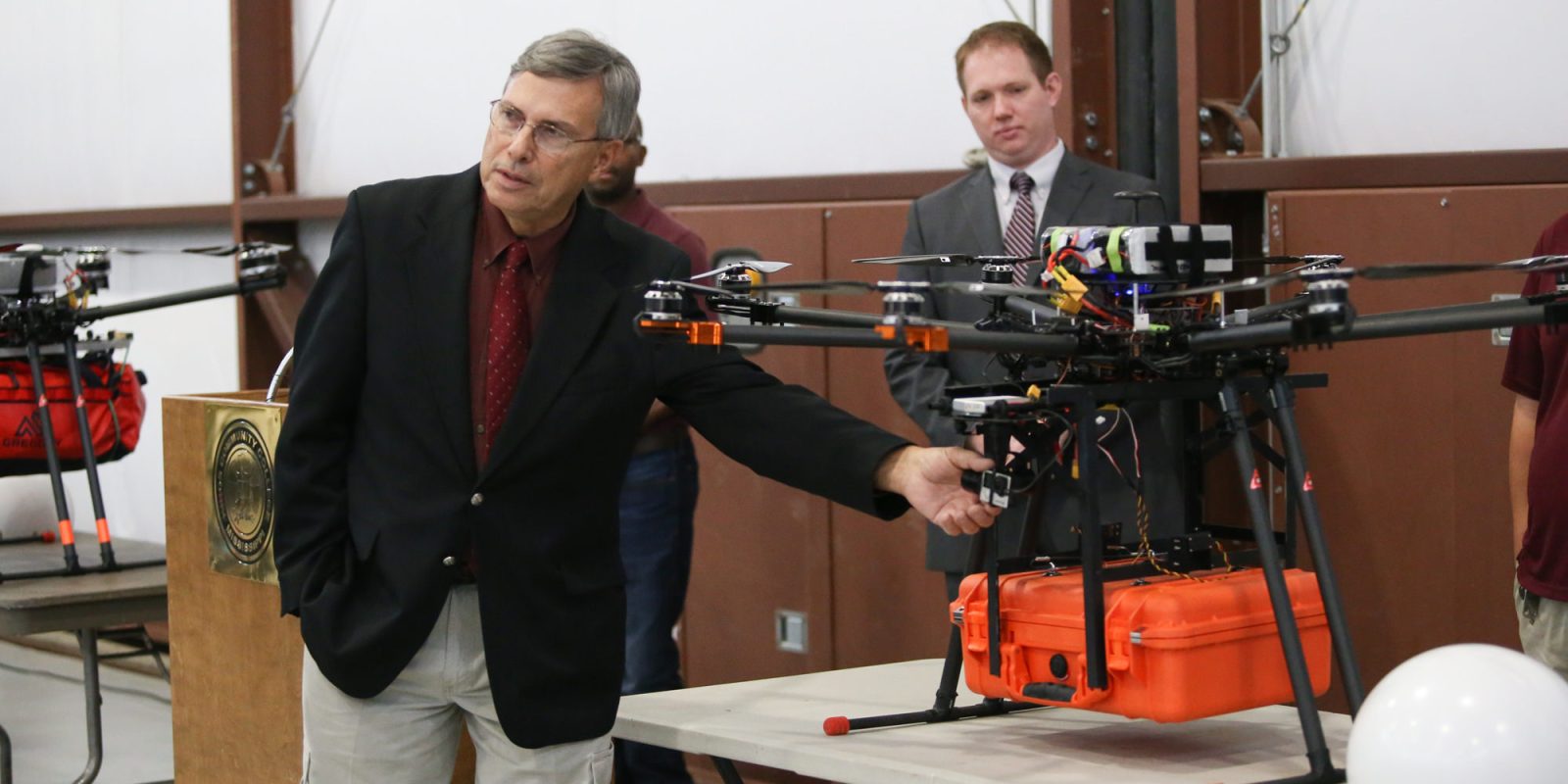 Dennis Lott, director of the Unmanned Aerial Systems program at Hinds Community College, points out a component on a UAV equipped with a telemedical package during a presentation Dec. 6 at John Bell Williams Airport to launch the Telemedical Drone Project. (Hinds Community College/April Garon)