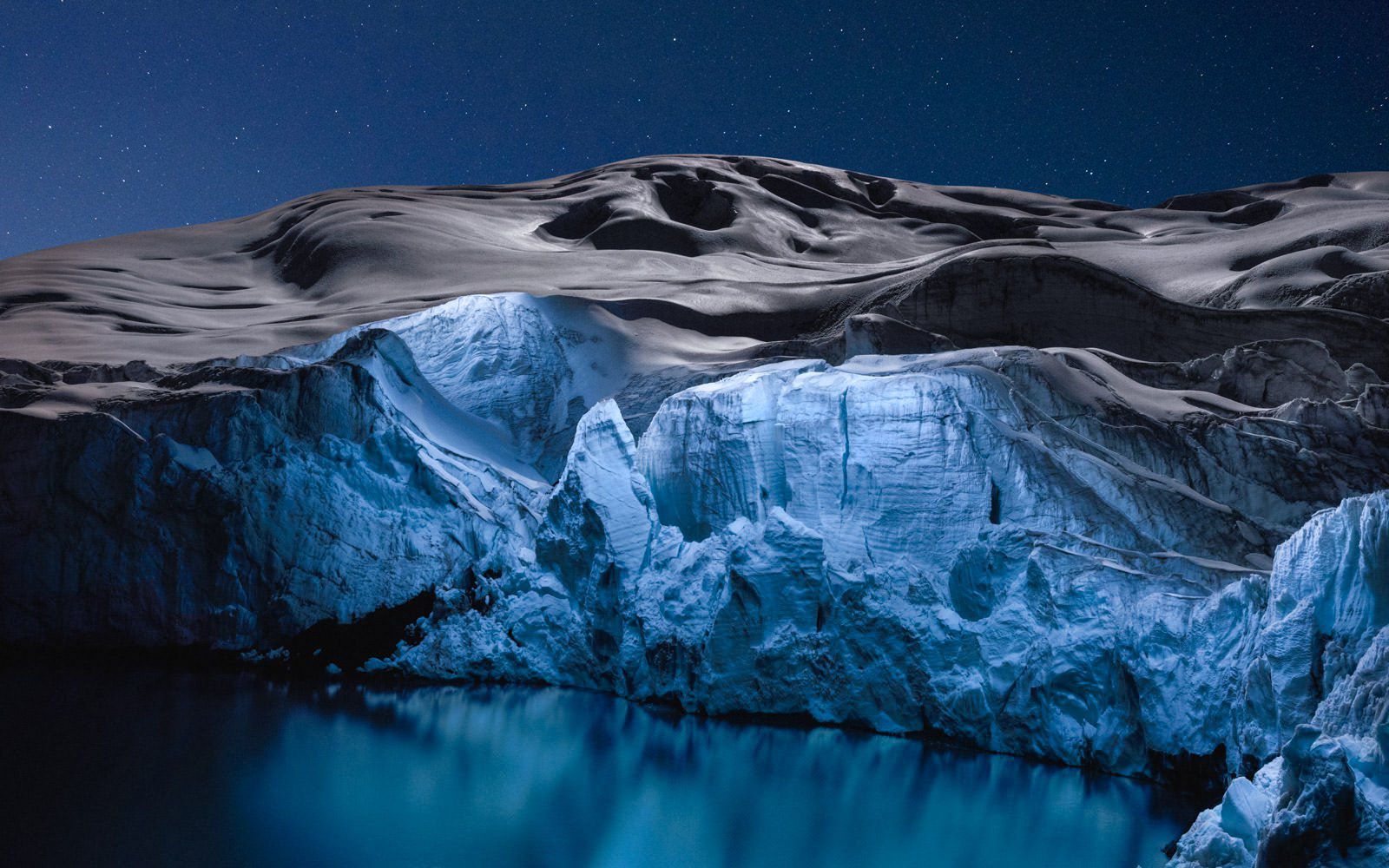 Glaciers dramatically lit up at night by a drone