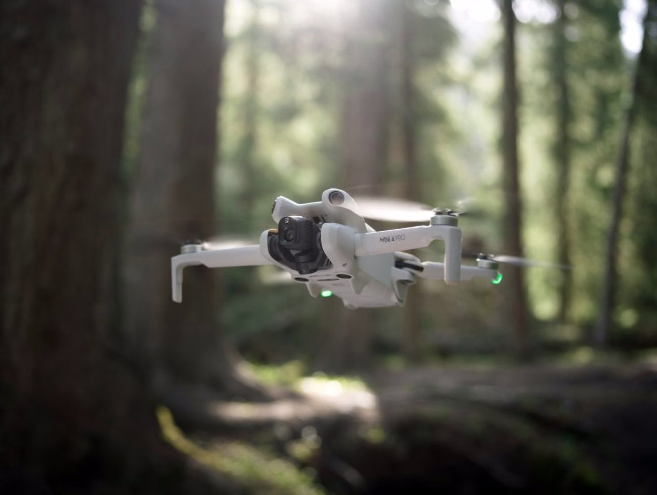 Mini 4 Pro drone flying in forrest